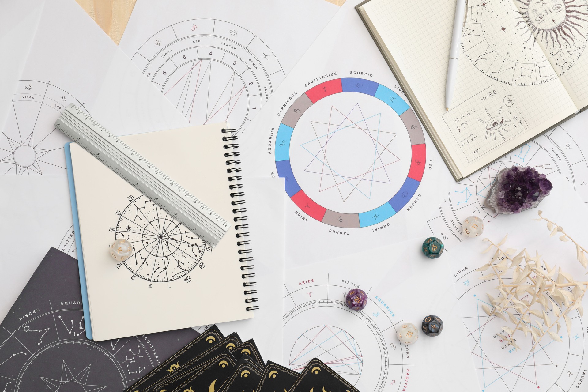 Natal charts for making forecast of fate and astrological items for fortune telling on table, flat lay